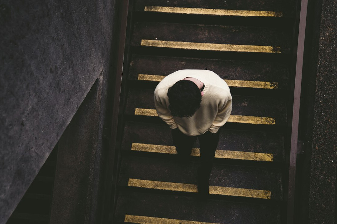 person climbing stairs to success