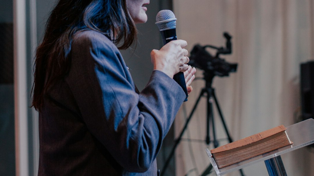 woman speaking confidently on stage